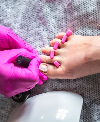 pedicurist-master-in-pink-gloves-cuts-the-cuticle-2026-01-09-06-37-04-utc